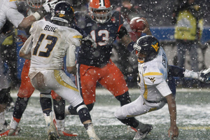 West Virginia quarterback Geno Smith is tripped up in his own end zone for a safety in the third quarter Saturday.