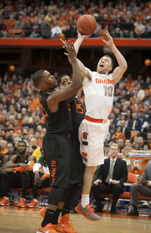 Trevor Cooney struggles to get a shot up in No. 2 Syracuse's gritty 49-44 win over Miami (Fla.) on Saturday. 