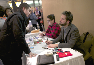 Alexis Ohanian, co-founder of Reddit, signs copies of his book “Without Their Permission” on Tuesday. Ohanian encouraged Syracuse University students to use available Internet resources to pursue their entrepreneurial ambitions.   