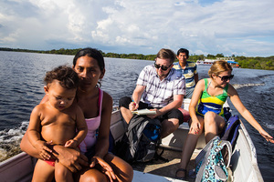 Greg Bishop ('02) rides in a boat outside Manaus, Brazil, en route to go piranha fishing. (He caught one that day).