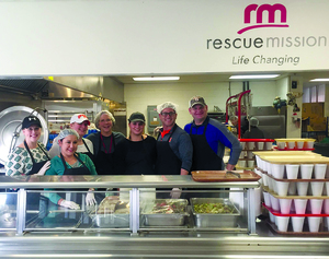 The Changing Lives group is one of the community groups that volunteered at the Syracuse Rescue Mission's Food Service Center.