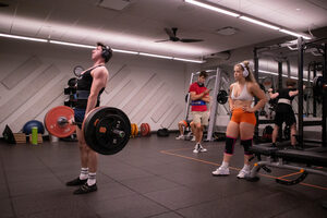 Senior Lili Williams watches over sophomore Brandon Lyubarsky as he lifts in the Barnes Center at The Arch. Both students are members of Orange Barbell, a casual lifting club that features biweekly master classes, weekly group lifts and friendly lifting challenges.