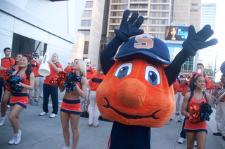 Otto the Orange performs with the Sour Sitrus Society and Syracuse University cheerleaders outside of The Hudson Grille.