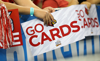 Fans of the Louisville Cardinals hold posters before the game against the Witchita State Shockers.