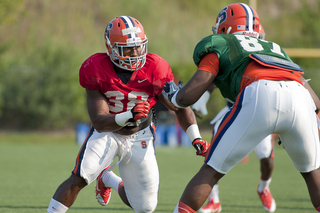 Junior linebacker Cam Lynch tries to rush past freshman offensive lineman Kendall Moore.