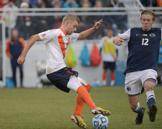 Syracuse midfielder Julian Buescher looks to elude Griffith.