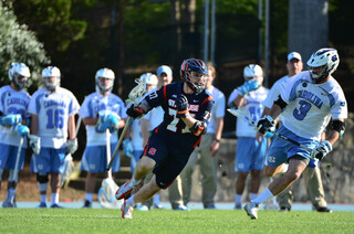 Midfielder Henry Schoonmaker dodges against UNC's Brett Bedard. The SU senior had only one goal on the day.