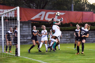 Players fight for position just in front of the goal. 