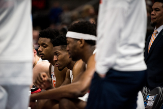 Players listen to Boeheim during a timeout. 