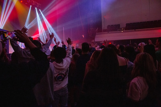 Zach Fox gets all the students to wave their arms as he plays “Jesus Is The One (I Got Depression)”. 
