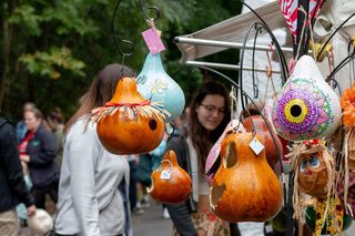 Two women check out one of the many vendor tents at the 44th annual Golden Harvest Festival in Baldwinsville, NY. This one featured handmade bird feeders in a variety of colors, shapes and themes. 